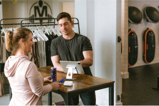 Cashier ringing up customer in clothing store